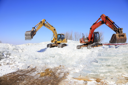 Luannan County - January 23, 2018: Excavator collate ice in the field, Luannan County, Hebei Province, Chinaのeditorial素材