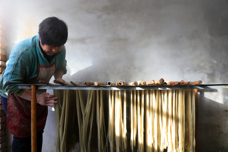 Luannan County - January 31, 2018: workers busy in producing vermicelli workshop, Luannan County, Hebei Province, Chinaのeditorial素材