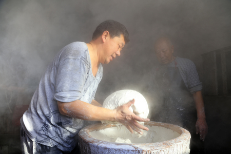 Luannan County - January 31, 2018: workers busy in producing vermicelli workshop, Luannan County, Hebei Province, Chinaのeditorial素材