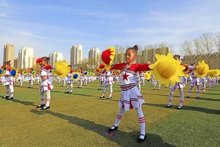 Luannan County - April 11, 2018: Primary and middle school students' spring track and field gymnastics group Gymnastics, Luannan, Hebei, China.のeditorial素材