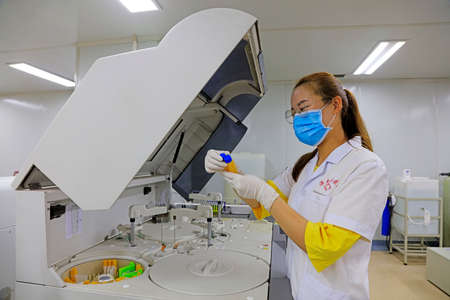 Luannan County - September 7, 2018: A female inspector is conducting a test analysis, Luannan County, Hebei Province, Chinaのeditorial素材