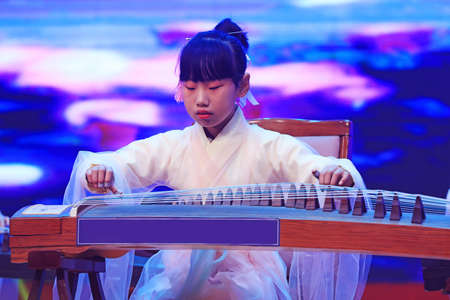 Luannan County - January 29, 2019: girl guzheng performance on the stage, Luannan County, Hebei...