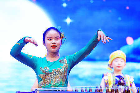Luannan County - January 27, 2019: girl guzheng performance on the stage, Luannan County, Hebei Province, Chinaのeditorial素材
