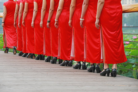 Women in red cheongsams are performing in a walk show, Luannan County, Hebei Province, Chinaの写真素材