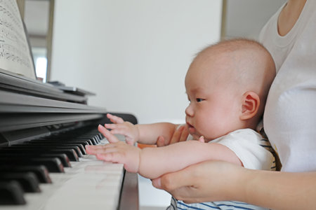 Luannan County, China-September 14, 2019: A baby plays in bed, Luannan County, Hebei Province, Chinaの写真素材