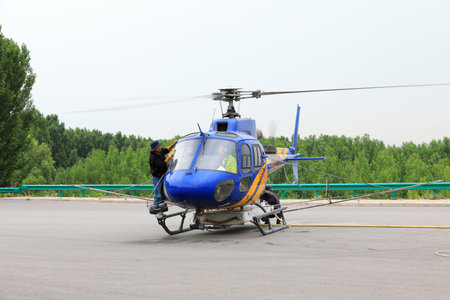 Luannan County, China-June 16, 2019: Workers wipe windshields of agricultural helicopters, Luannan County, Hebei Province, Chinaのeditorial素材