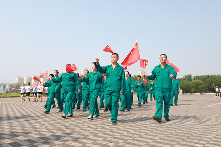 Luannan County, China-12 July, 2019: People waved flags in the square, Luannan County, Hebei Province, Chinaのeditorial素材