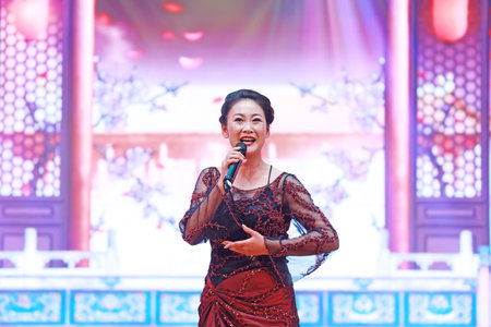 Luannan County, China-August 15, 2019: Female singing on stage, Luannan County, Hebei Province, Chinaのeditorial素材