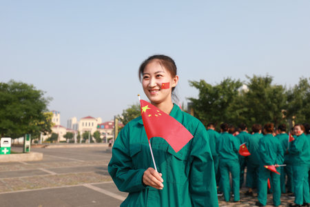 Luannan County, China-12 July, 2019: People waved flags in the square, Luannan County, Hebei Province, Chinaのeditorial素材