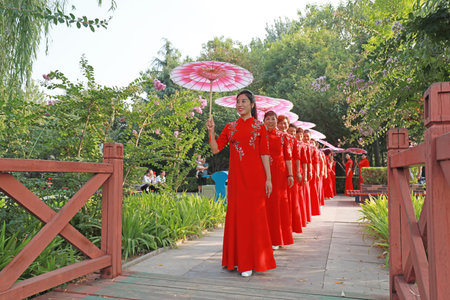 Luannan County, China-August 27, 2019: Chinese Cheongsam Walking Show in the Park, Luannan County, Hebei Province, Chinaのeditorial素材
