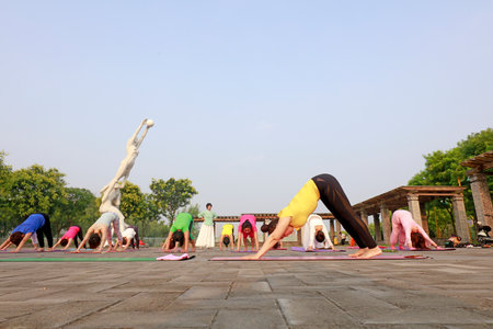 Luannan County-July 22, 2018: Ladies practicing yoga on the square, Luannan County, Hebei Province, Chinaのeditorial素材