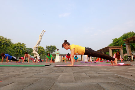 Luannan County-July 22, 2018: Ladies practicing yoga on the square, Luannan County, Hebei Province, Chinaのeditorial素材