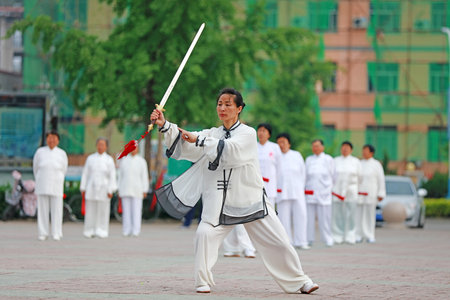 Luannan County-May 19, 2019: Chinese Tai Chi Sword Performing in Square, Luannan County, Hebei Province, Chinaのeditorial素材