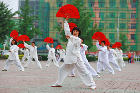 Luannan County-May 19, 2019: Chinese Tai Chi Kung Fu Fan Performing in Square, Luannan County, Hebei Province, Chinaのeditorial素材