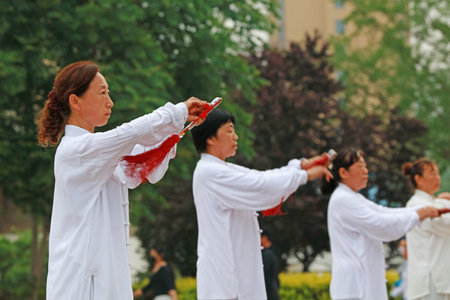 Luannan County-May 19, 2019: people doing traditional Tai Chi Chuan in the park for healthy, traditional Chinese martial arts concept, Luannan County, Hebei Province, Chinaのeditorial素材
