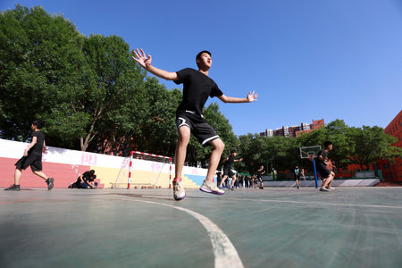 Luannan County-May 31, 2019: Handball players perform daily training on the playground, Luannan County, Hebei Province, Chinaのeditorial素材