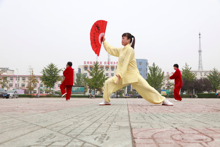 LUANNAN COUNTY, China-October 15, 2017: Tai Chi Kung Fu Fan Performance in the square, LUANNAN COUNTY, Hebei Province, Chinaのeditorial素材