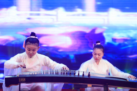 Luannan County-January 29, 2019: girl guzheng performance on the stage, Luannan County, Hebei Province, Chinaのeditorial素材