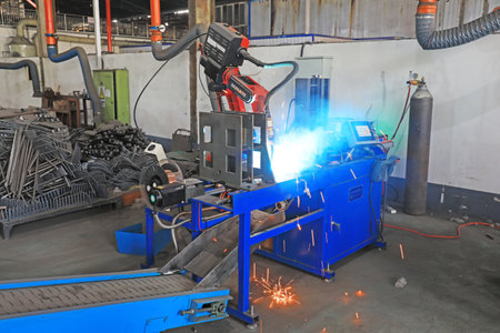 Luannan County, China-June 21, 2019: Workers inspect the work of intelligent welding robots in a...