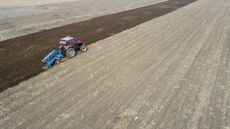 Farmers flatten their land with turning ploughs for spring ploughing, North China