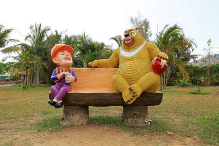 Giant bear and bareheaded cartoon sculpture in park, Sanya, South Chinaの写真素材