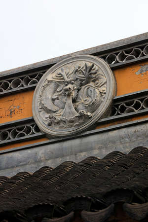 Religious carved symbols on the ridge of Chenxiang Pavilion, Shanghai, Chinaの写真素材