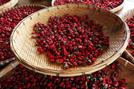 The dried roses are in the basket, in a rose processing factory, Sanya, South Chinaの写真素材