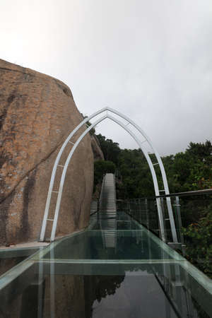 Sanya City, China-April 1, 2019: Sea view glass trestle building scenery, Sanya City, Hainan Province, Chinaのeditorial素材