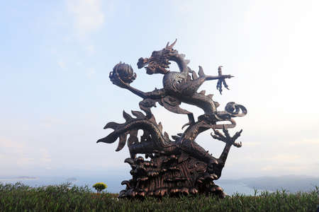 Sanya City, China-April 1, 2019: Chinese dragon sculpture in tropical paradise forest park, Sanya City, Hainan Province, Chinaのeditorial素材