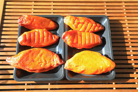 Baked sweet potatoes in a plastic tray in a restaurant, China