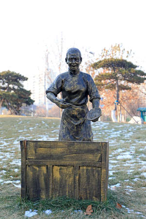 Tangshan City, China-December 22, 2020: Bronze sculptures of Qing Dynasty figures in a park, Tangshan City, Hebei Province, Chinaのeditorial素材