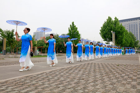 LUANNAN COUNTY, China-June 9, 2018: Women in cheongsam perform in the park, LUANNAN COUNTY, Hebei Province, Chinaのeditorial素材