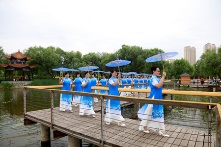LUANNAN COUNTY, China-June 9, 2018: Cheongsam lady shows in the park, LUANNAN COUNTY, Hebei Province, Chinaのeditorial素材