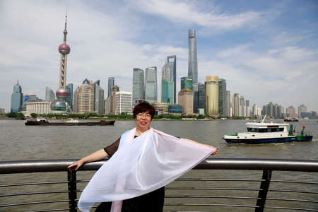 Shanghai, China-June 2, 2018: A lady is traveling on the Bund of Shanghai,Chinaのeditorial素材
