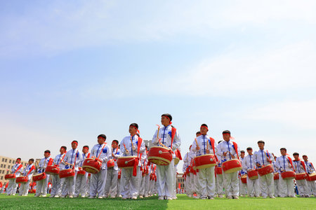 LUANNAN COUNTY, China-April 8, 2019: The percussion band is beating the drum at the sports meeting, LUANNAN COUNTY, Hebei Province, Chinaのeditorial素材
