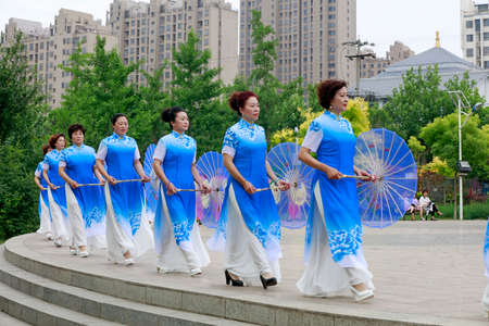 LUANNAN COUNTY, China-June 9, 2018: Women in cheongsam perform in the park, LUANNAN COUNTY, Hebei Province, Chinaのeditorial素材