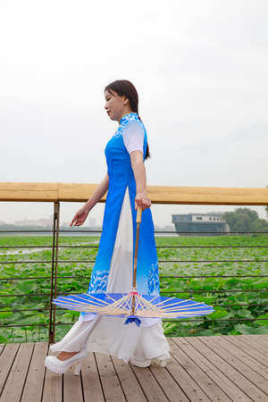 LUANNAN COUNTY, China-June 9, 2018: Cheongsam lady shows in the park, LUANNAN COUNTY, Hebei Province, Chinaのeditorial素材