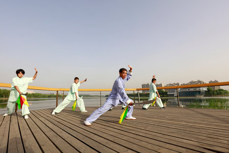 LUANNAN COUNTY, China-May 27, 2018: Teenagers are learning taijidao in the park, LUANNAN COUNTY, Hebei Province, Chinaのeditorial素材