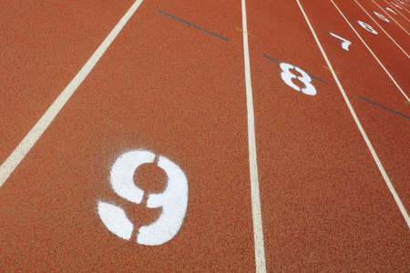 The white numbers on the plastic track are on the playground