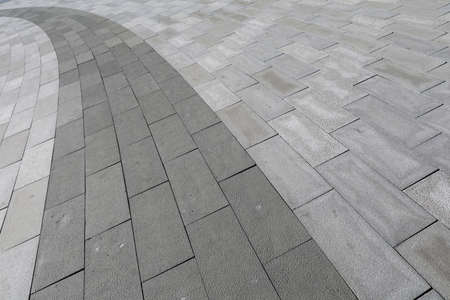 Roads paved with grey floor tiles