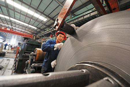 LUANNAN COUNTY, Hebei Province, China-March 25, 2020: Workers are busy on the strip production line in a factory.のeditorial素材
