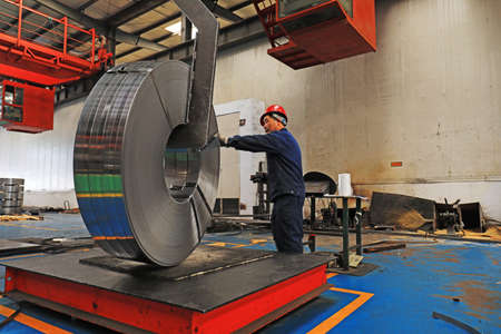 LUANNAN COUNTY, Hebei Province, China-March 25, 2020: Workers are busy on the strip production line in a factory.のeditorial素材