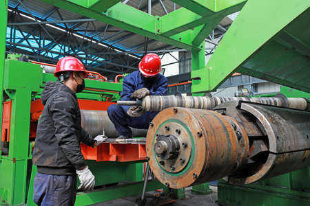 LUANNAN COUNTY, Hebei Province, China-March 25, 2020: Workers are busy on the strip production line in a factory.のeditorial素材