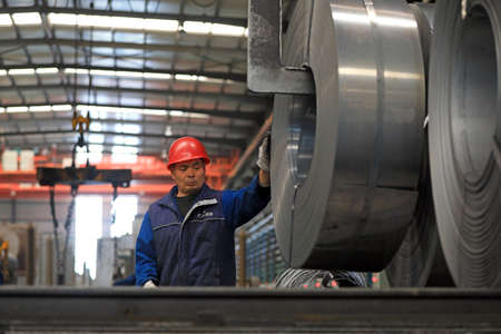 LUANNAN COUNTY, Hebei Province, China-March 26, 2020: Workers are busy on the strip production line in an iron and steel company.のeditorial素材