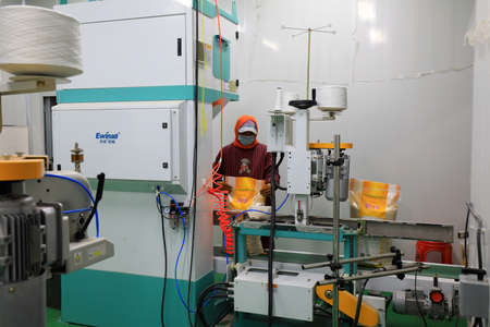LUANNAN COUNTY, Hebei Province, China-November 5, 2020: The workers are busy on the production line of the rice processing plantのeditorial素材