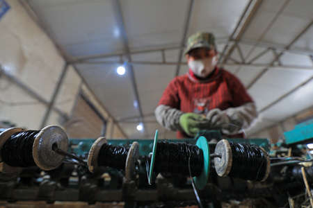 LUANNAN COUNTY, Hebei Province, China-November 12, 2020: The workers are working. The reed curtain is in the workshopのeditorial素材