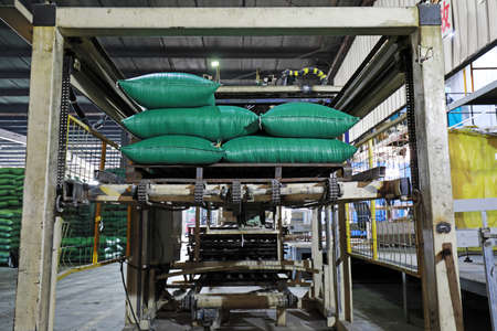 LUANNAN COUNTY, Hebei Province, China-March 17, 2020: Workers are busy in the feed packaging...