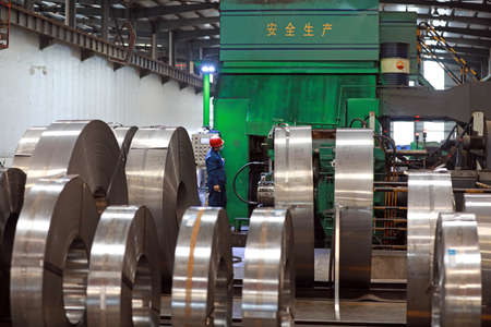 LUANNAN COUNTY, Hebei Province, China-March 26, 2020: Workers are busy on the strip production line in an iron and steel company.のeditorial素材