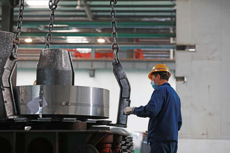 LUANNAN COUNTY, Hebei Province, China-March 26, 2020: Workers are busy on the strip production line in an iron and steel company.のeditorial素材