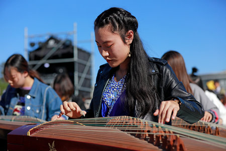 Tangshan City, China-October 7, 2018: Guzheng playing performance in the park, Hebei Province, Chinaのeditorial素材